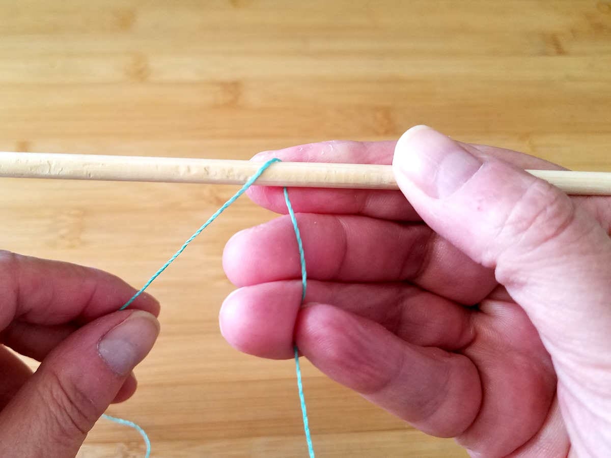 Bring the working end of the weaving wire over and around the front of the first core wires, as shown.