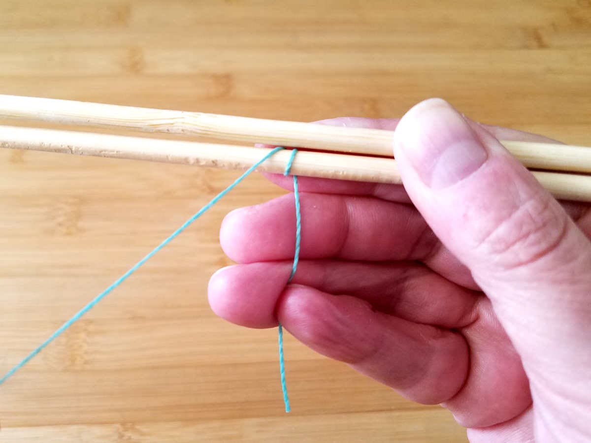 Complete one full wrap around Wire 1 before adding Wire 2 to the stack. The working end of your core wire should be between the two core wires with the working end in front, as shown.