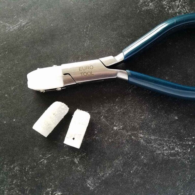 A pair of nylon jaws pictured with a set of worn jaws