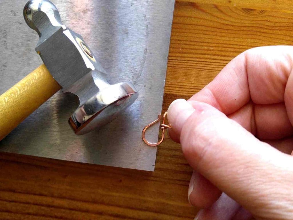 Step 6 - Use your chasing hammer and bench block to flatten the ends of the loops and the point of the hook, as shown. 