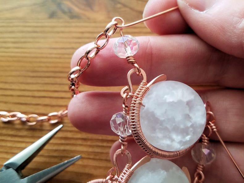 Chain Step 4 - Thread an accent bead onto the looped head pin and attach the connector to one end of the chain with another wrapped loop, as shown.