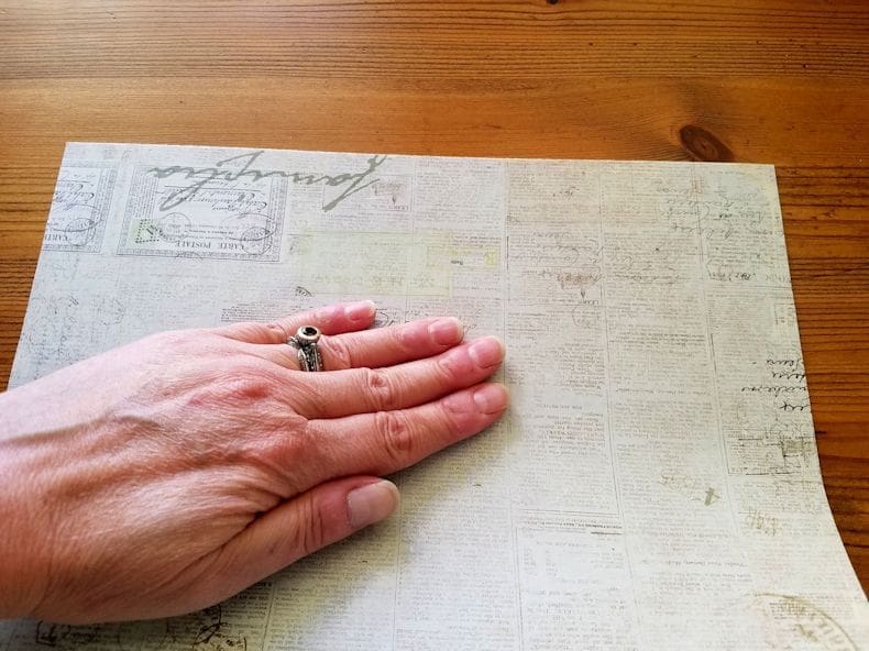 Step 3 - Smooth the paper onto the floor tile using the palm of your hand or a plastic credit card.