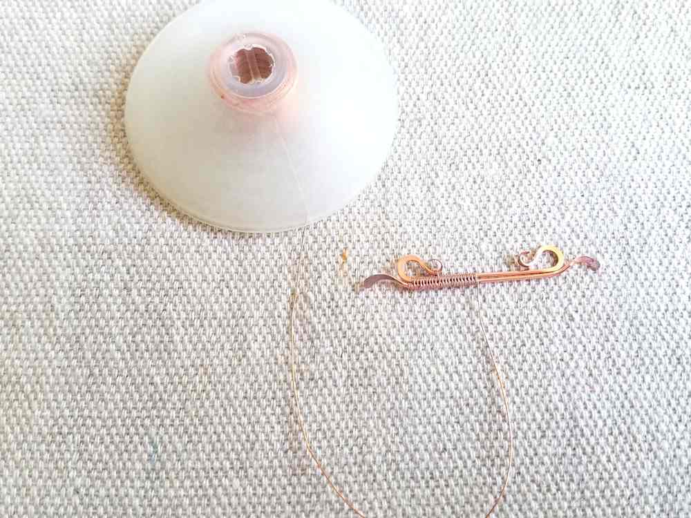 Delicate Bar Pendant, Step 11: Begin weaving the two core wires together. Work from the center out toward one end of the bar and use the modified Soumak weave