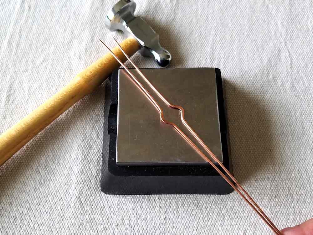 Step 15 - Use a chasing hammer and bench block to work harden the bends in the two 16ga frame wires.