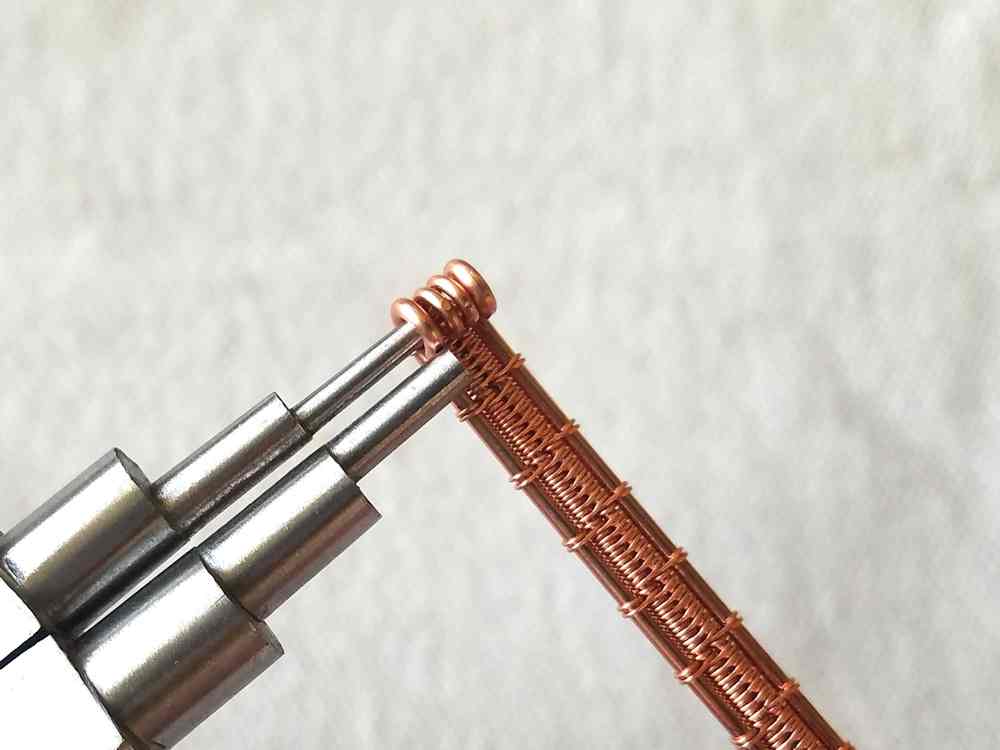 Step 32 - Loop the ends of the woven core wires using the 2mm step on your stepped bail-making pliers.