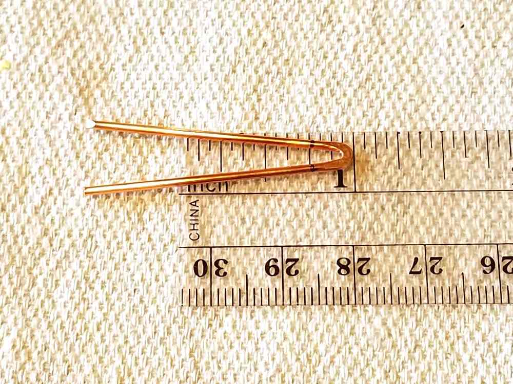 Work harden the tip of the hook with a bench block and chasing hammer. Then measure and mark both arms of the V at 1/4 inch from the tip of the hook.