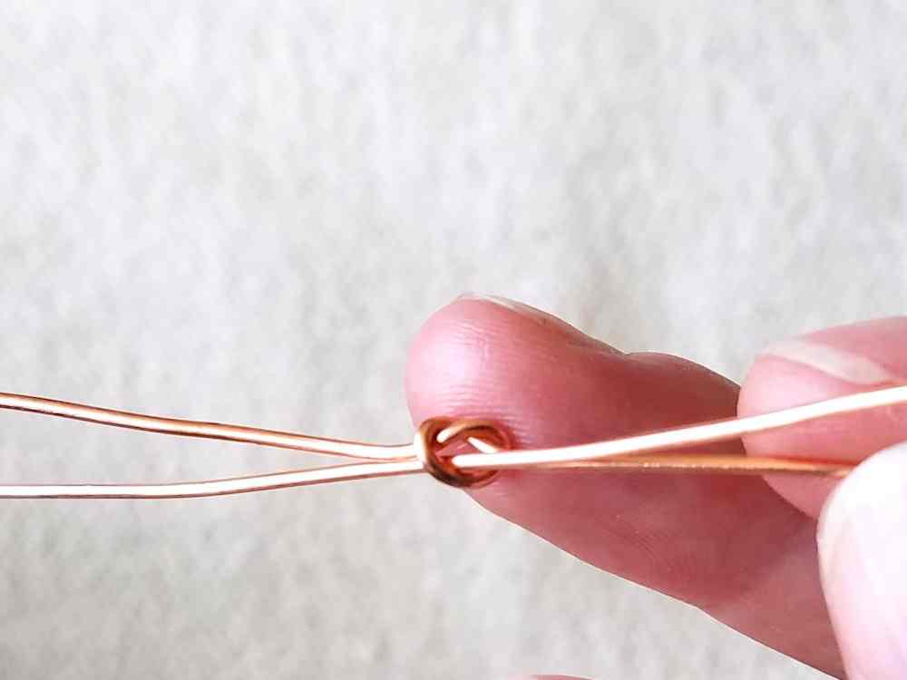Step 5 - thread your second 18ga core wire through the first knot, from back to front.