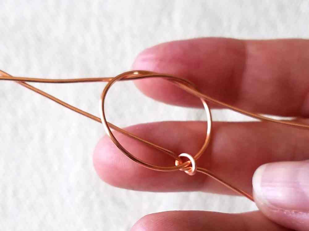 Step 6 - tighten both knots until they snug up against one another and the core wires are parallel