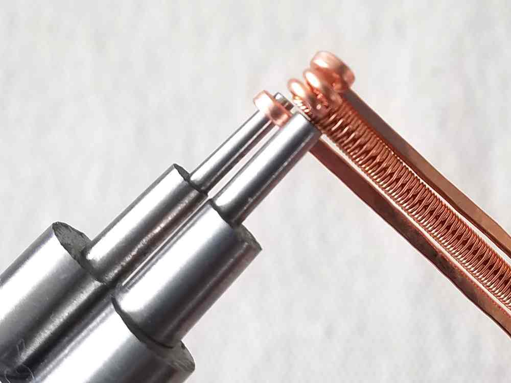 Use the 2mm step on your stepped bail-making pliers to form tight loops on all four core wires. Repeat on the other side, making sure your loops are all facing the wrong side of your band.