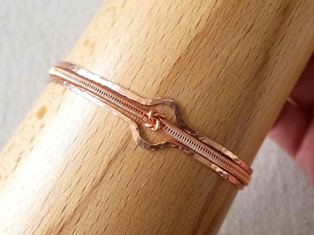 Form the bracelet into its finished shape. Use of a bracelet mandrel, as shown, is optional.