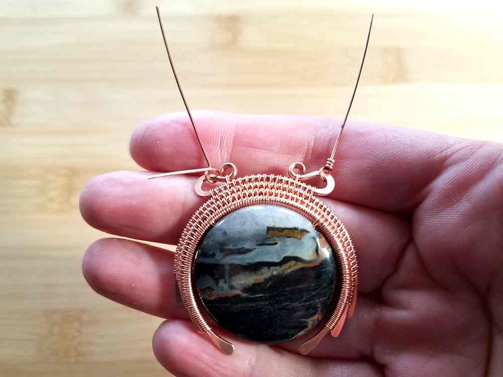 Step 24 - Using two of the wires cut in the previous step, attach a wrapped loop to each side of the pendant's bail wire. 