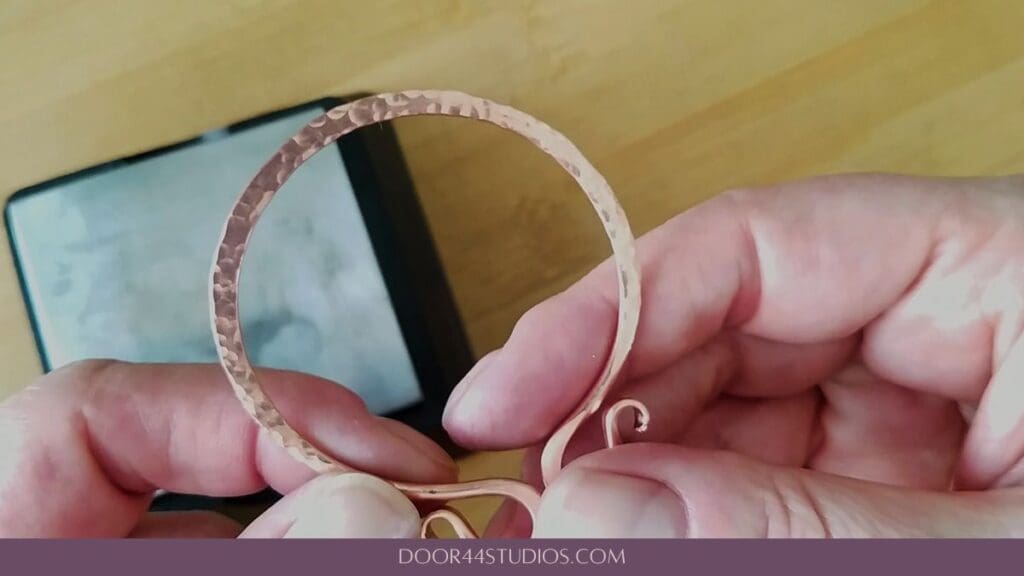 A view of the circlet after the flattened line was textured with the ball end of a chasing hammer