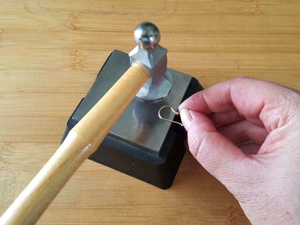 Work hardening the hooks with a chasing hammer and bench block