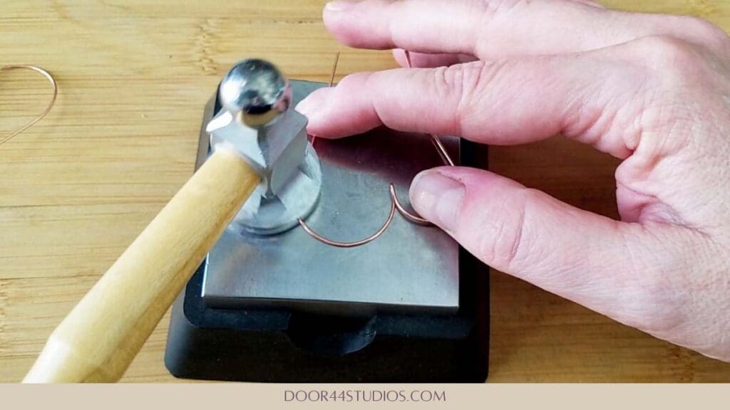 Hardening the wire with a chasing hammer
