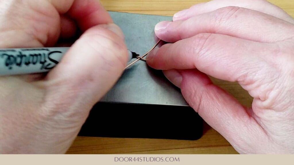Marking the wire at the point where the hook will be formed