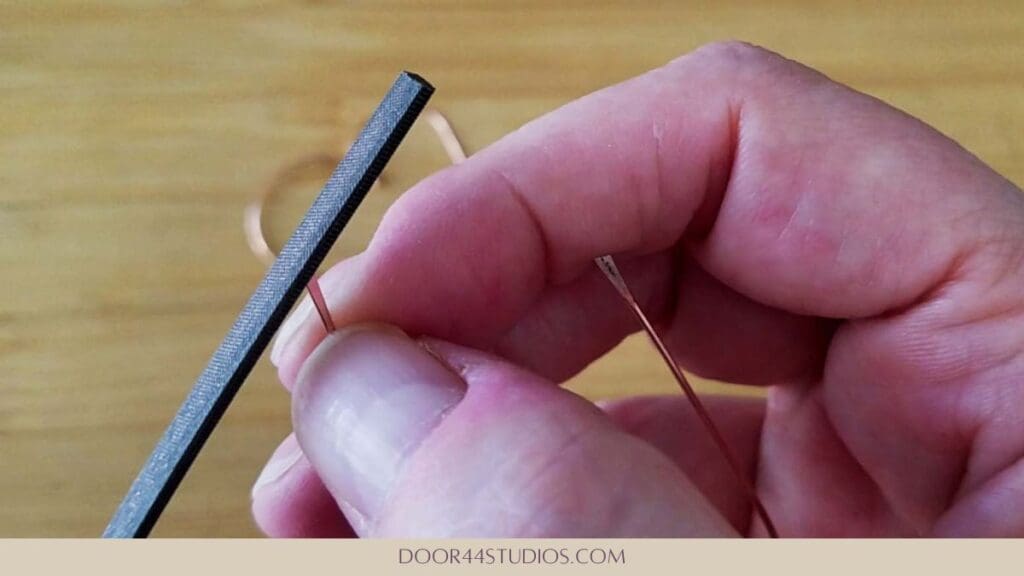 Smooth off any sharp edges of the paddled ends with a needle file, as shown.